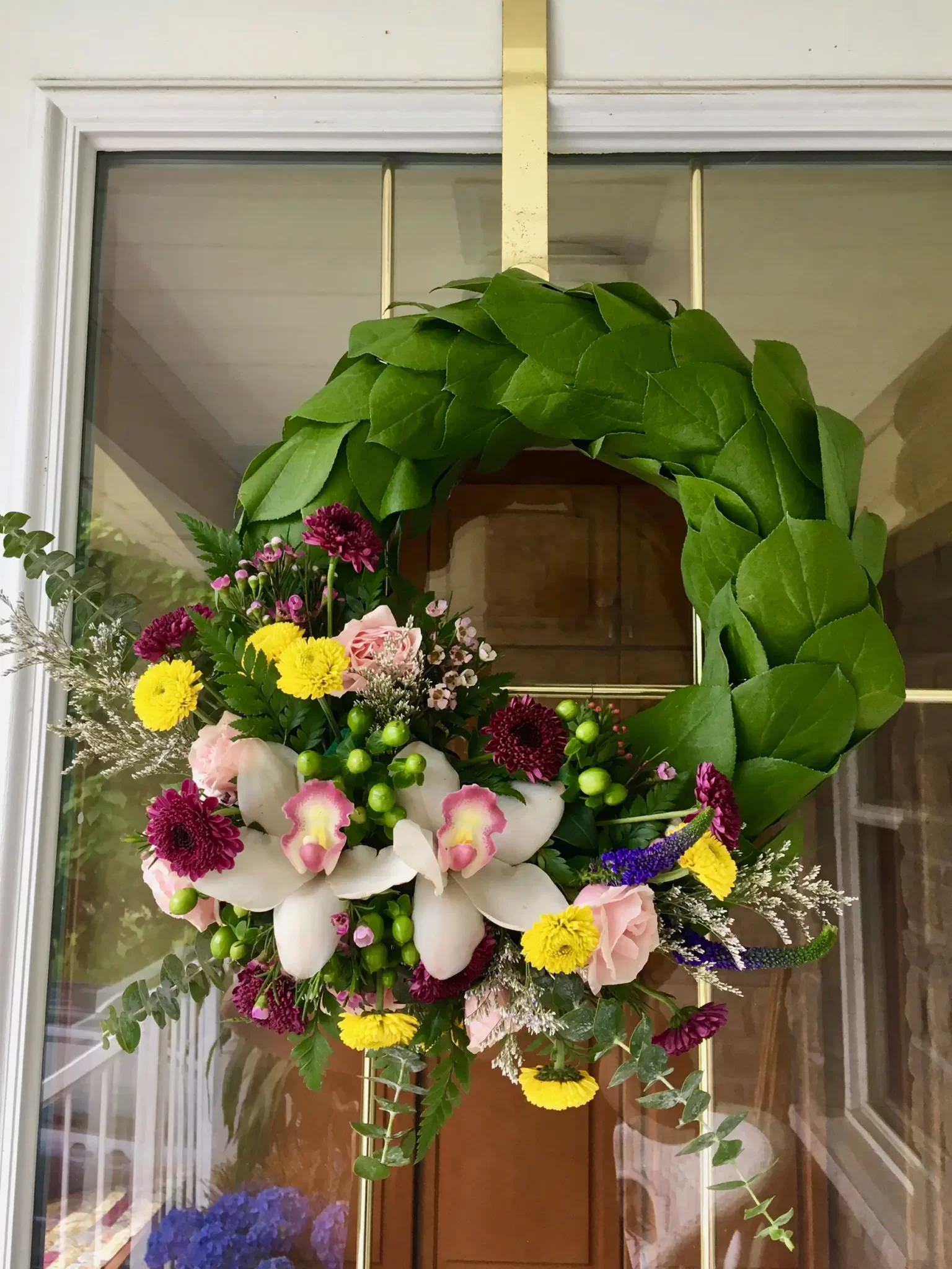 Hand delivered floral wreath hung on door